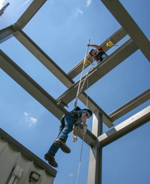 FrenchCreek-protected workers suspended at height on a steel structure, held by their fall-arrest lifelines